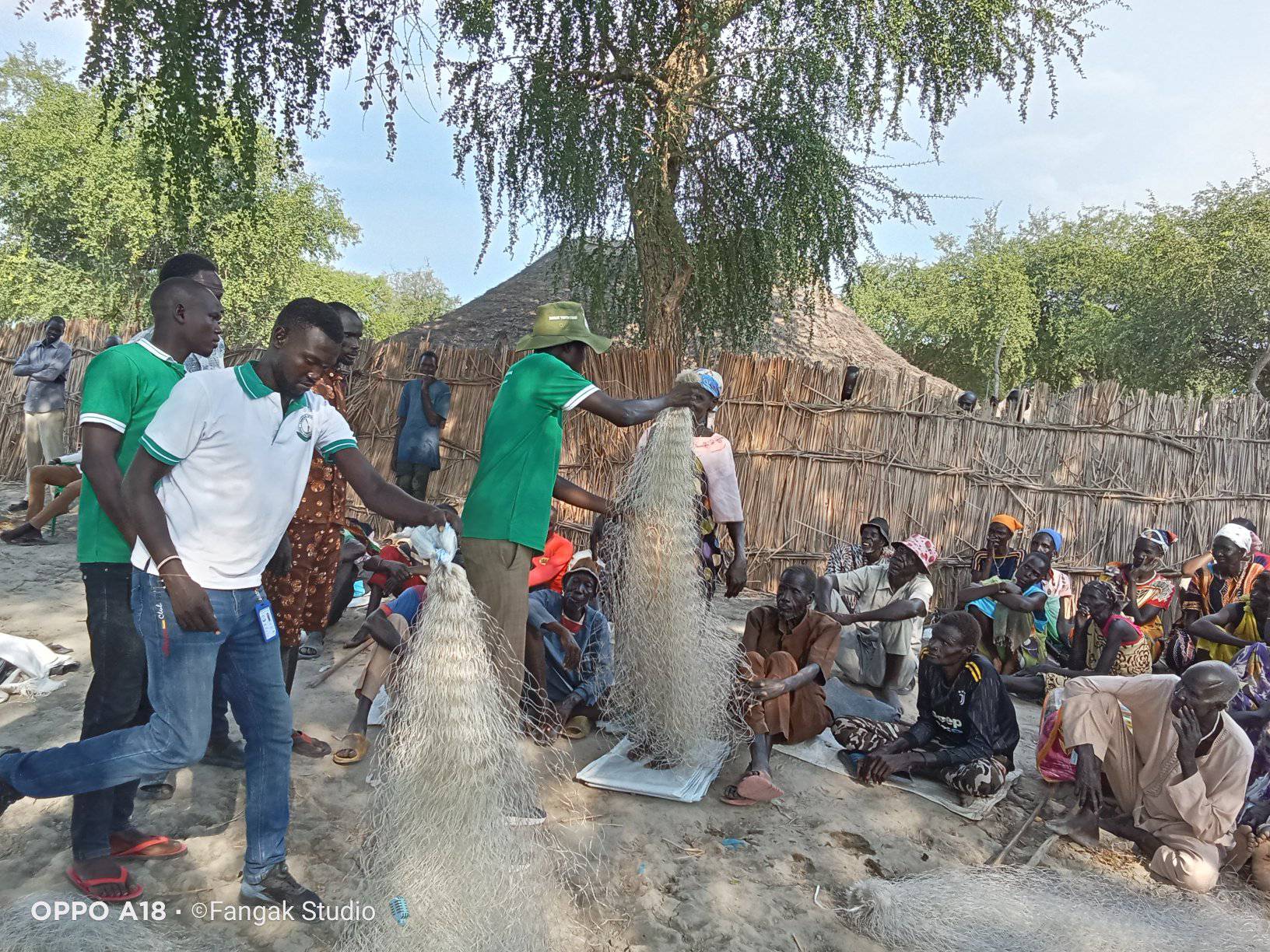 Fangak Chairperson & team distributing fishing nets to community elders